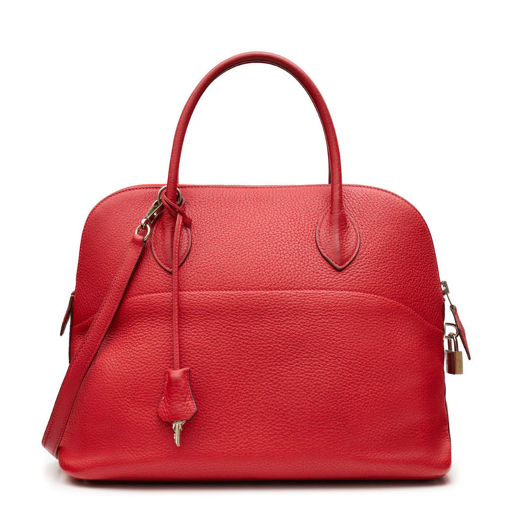 Hermès Red leather bolide handbag on a white background