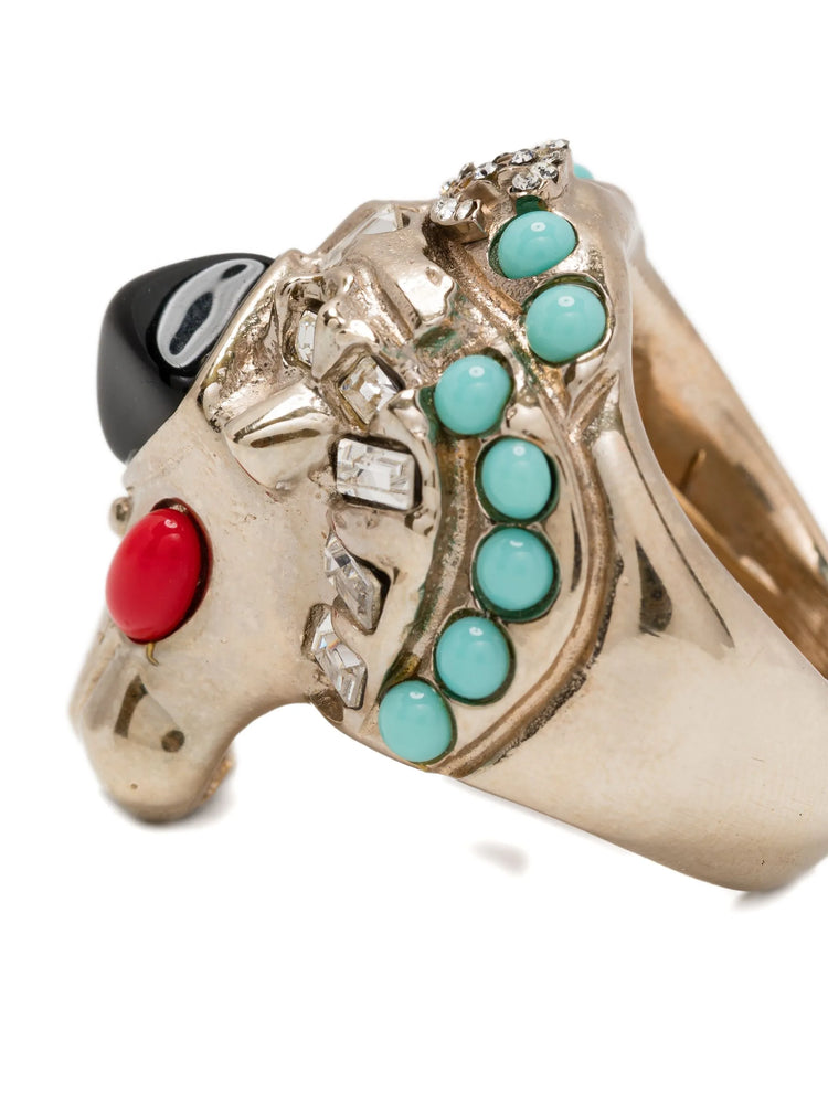 Chanel CC Lion Head Cocktail Ring with turquoise, black, and red stones on a white background