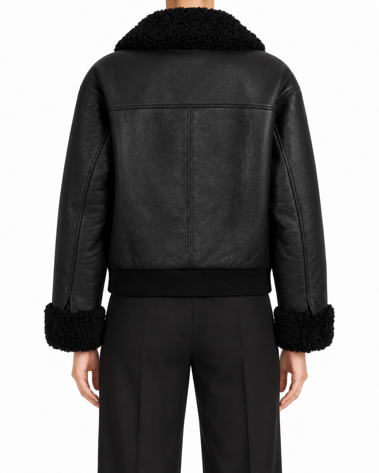Black Chanel leather shearling jacket, stylish blazer with a plush shearling collar and sleek leather finish.