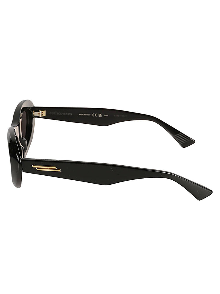 Black almond-shaped sunglasses by Bottega Veneta with sleek frames and tinted lenses.