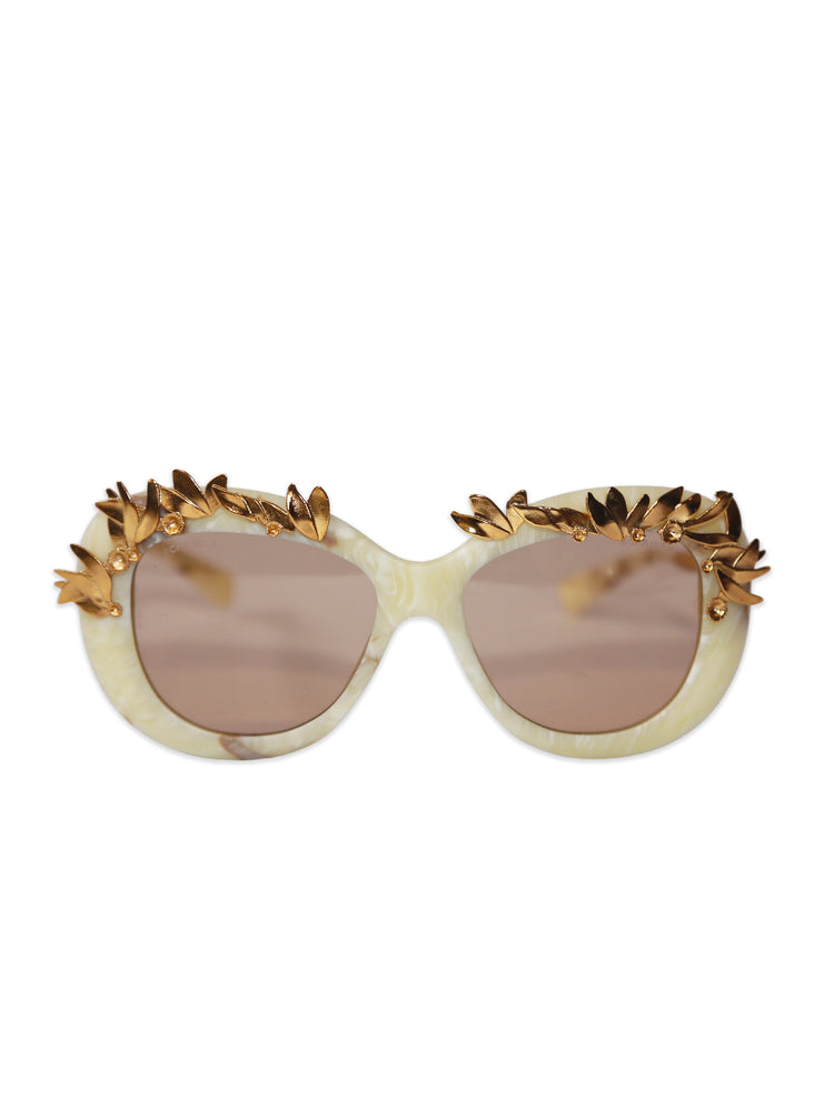 Chanel Sunglasses with gold decorative elements on a white background