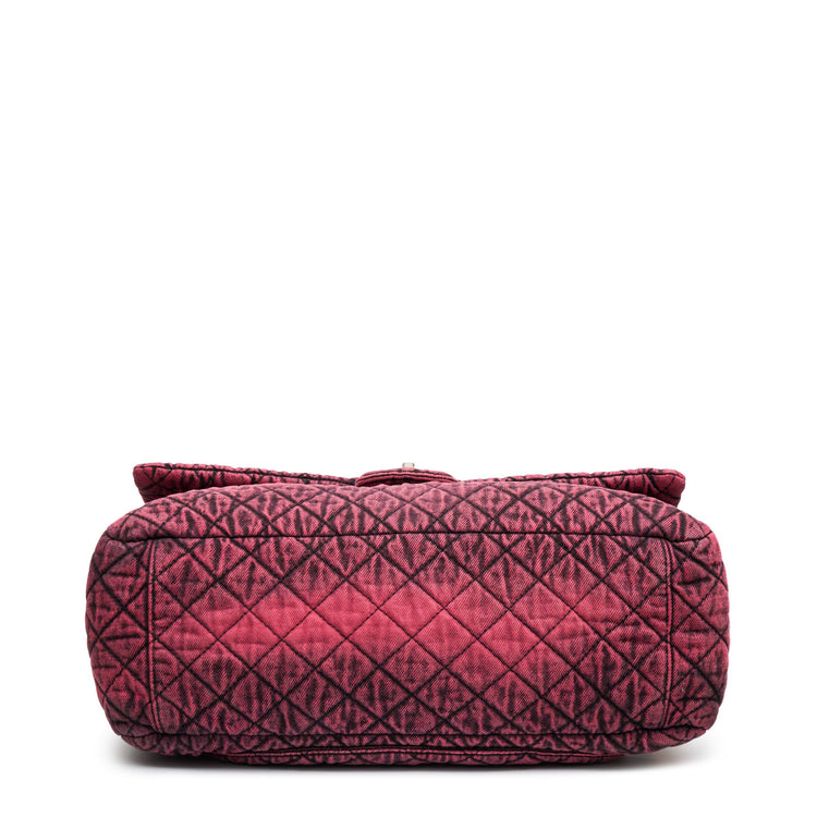 Chanel Airline pink denim XXL flap bag with black graphic quilted pattern, CC turn-lock closure, silver-tone hardware and chain-and-denim shoulder straps.