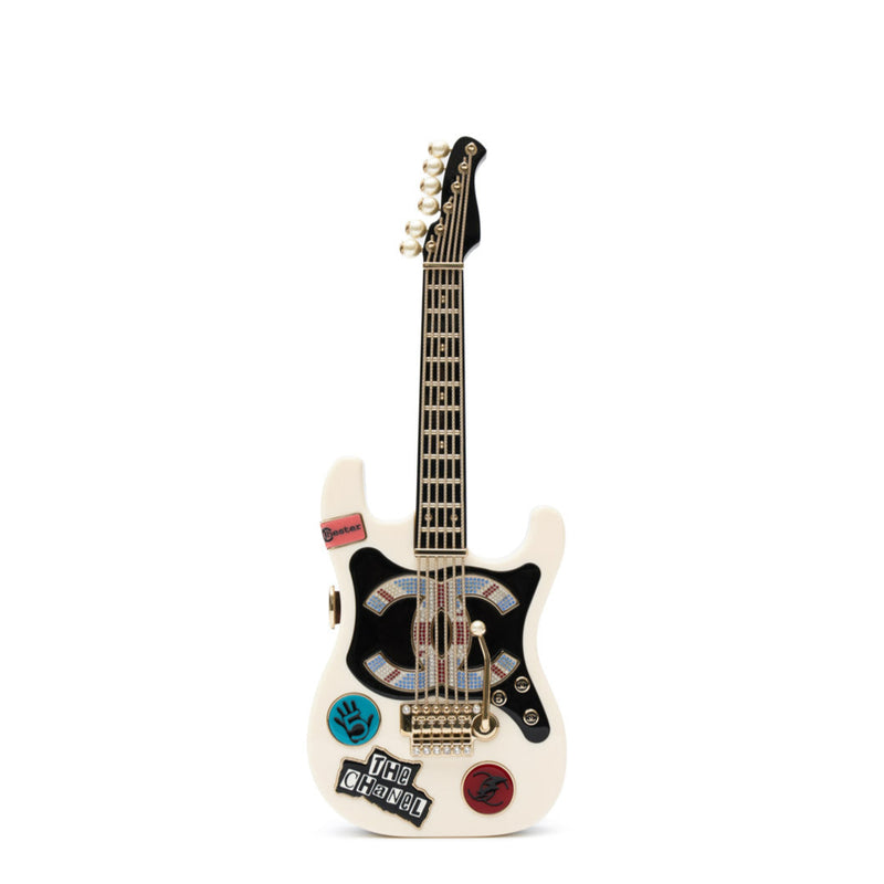 Chanel Collectible Guitar Minaudière Clutch Bag in white and black plexiglass with guitar-shaped design, CC logo detail, sticker-style motifs, pearl embellishment, gold-tone hardware, and chain shoulder strap.