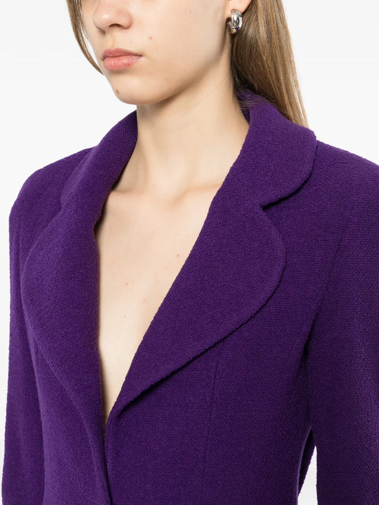 Chanel purple single-breasted tweed suit set featuring tailored blazer and matching trousers on a model.