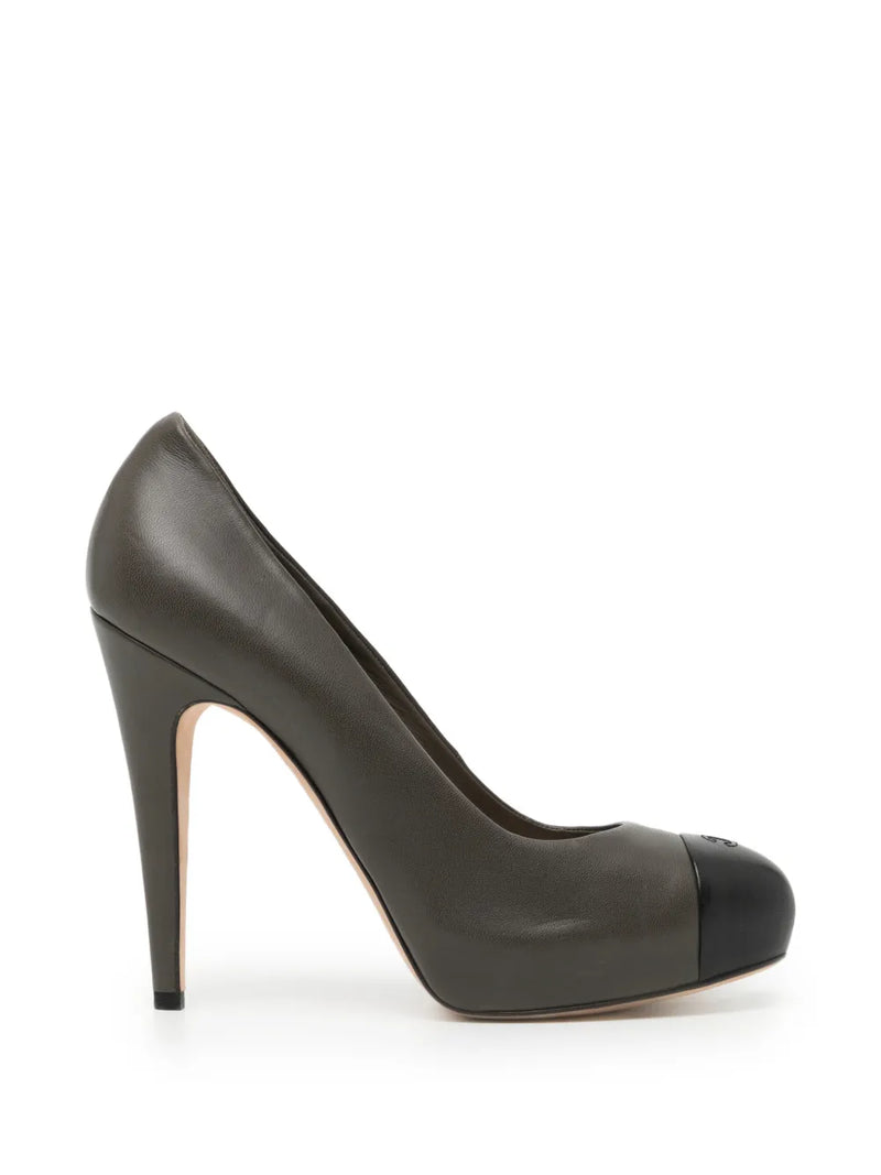 Chanel two-tone pumps shoes featuring classic black and beige leather with pointed toes and elegant design.