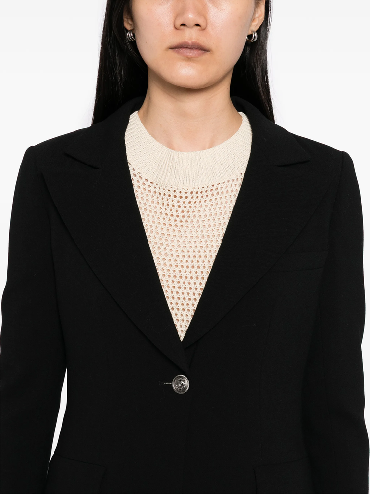 Black wool blazer by Chanel, tailored blazer with classic lapels and sleek fit, ideal for sophisticated and stylish outfits.