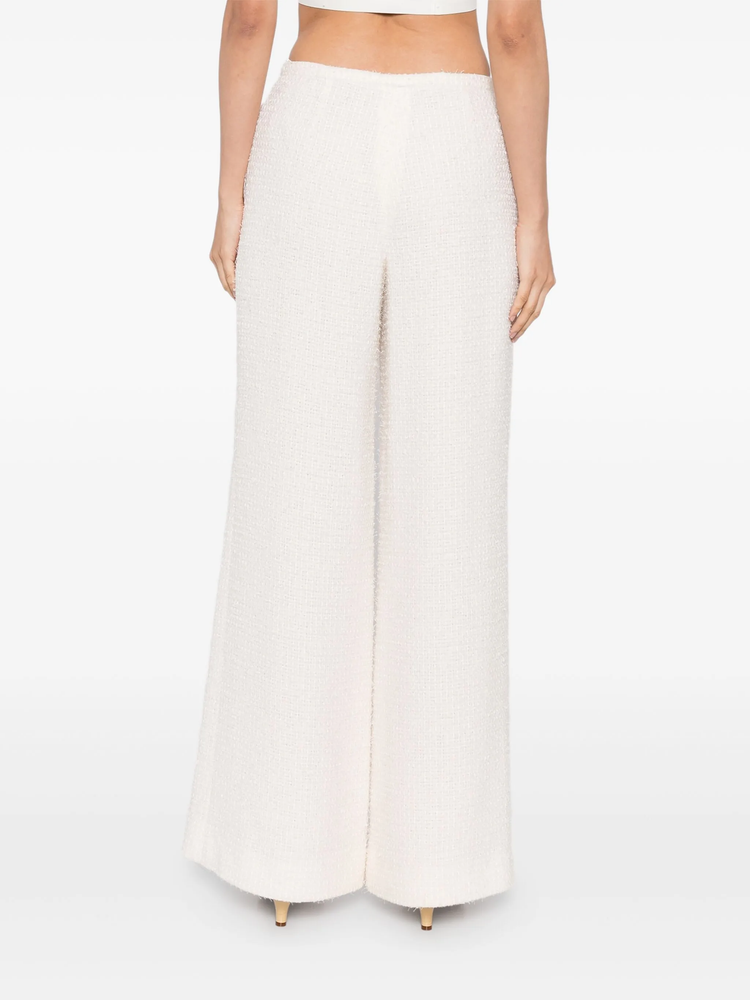 Cream tweed trousers by Chanel, tailored fit with classic textured fabric, stylish and versatile for elegant everyday wear.