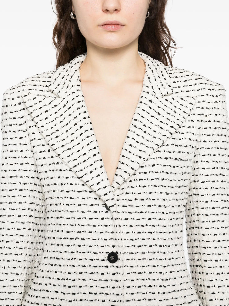 Chanel white and black textured tweed monochrome blazer with classic tailored fit, perfect for stylish formal or casual wear.