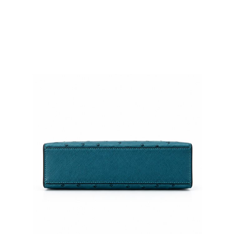 Hermès Kelly Pochette Bleu Colvert ostrich leather top handle bag with gold hardware, showcasing its elegant design and luxurious texture.