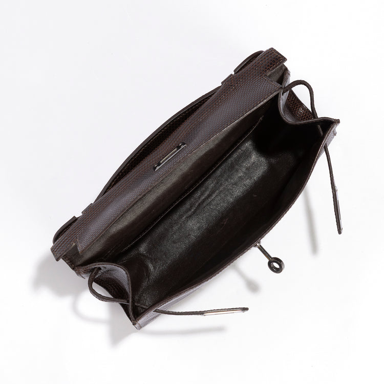 Hermès Chocolat Niloticus Lizard Kelly Pochette handbag with interior view, showcasing luxurious exotic leather and elegant craftsmanship.