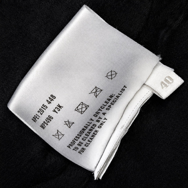 Black leather Miu Miu coat with shearling trim, featuring a classic collar and stylish silhouette.