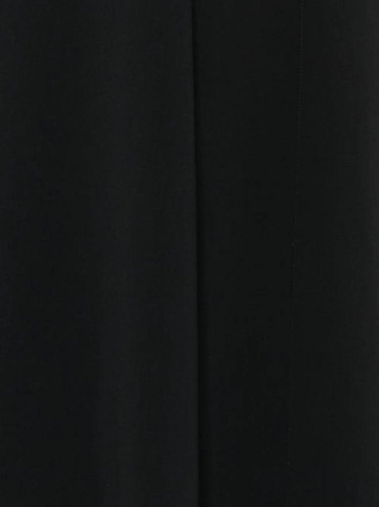 Black Thierry Mugler dress with orange accent details, elegant and stylish, showcasing a fitted silhouette with bold color contrast.