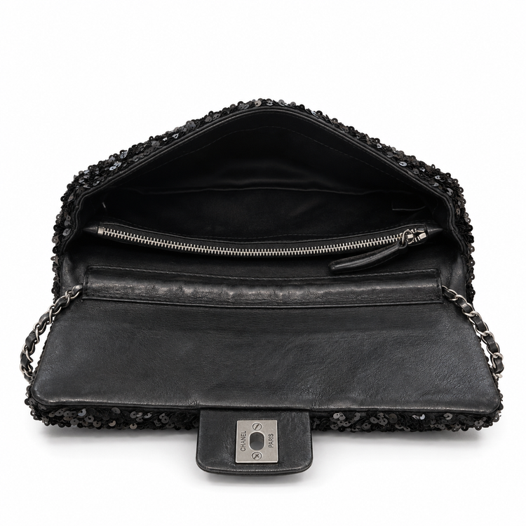 Open Chanel sequin east-west flap shoulder bag showing black interior lining and sleek design.