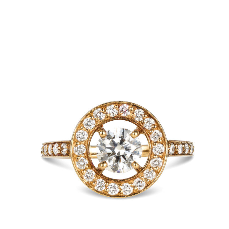 An 18kt yellow gold ring with a round brilliant cut natural diamond center stone, surrounded by smaller round brilliant cut natural diamonds set in a gold band.