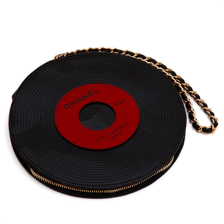 Chanel music record clutch bag in black leather with gold chain strap, designed for stylish storage of small essentials.