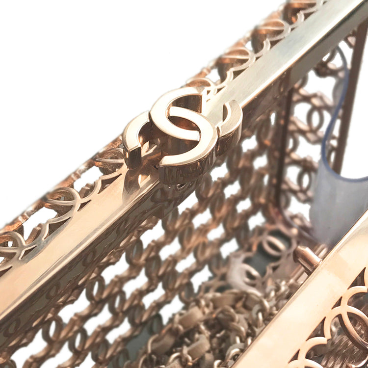 Gold Chanel logo cage chain clutch with gold clasp and chain strap, featuring a sleek and elegant design.