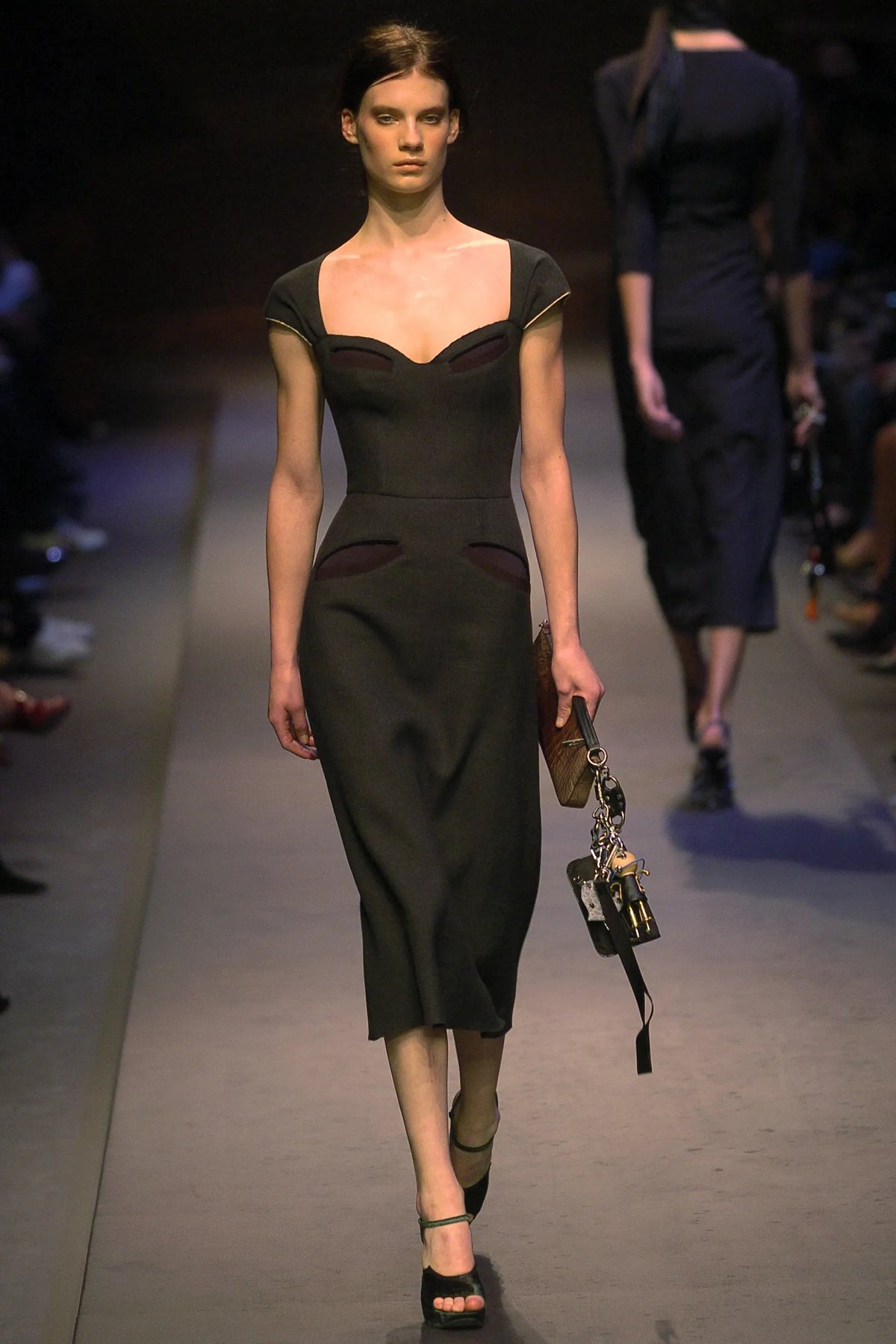 Prada 2004 black wool midi dress with sweetheart neckline, cap sleeves, contrast piping, cut-out detailing, fitted waist, exposed back zip and structured silhouette.