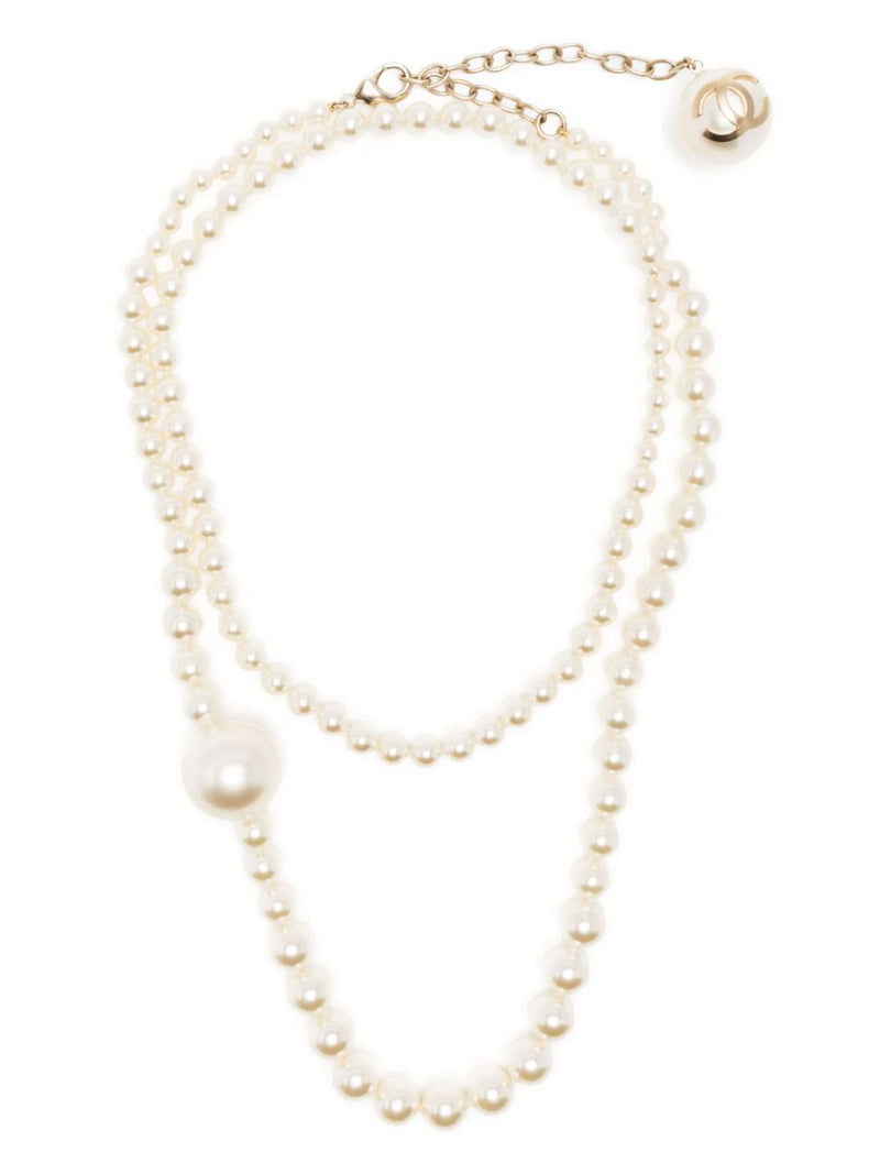 Chanel CC logo pearl necklace with elegant white pearls and silver chain, showcasing luxurious jewelry design.