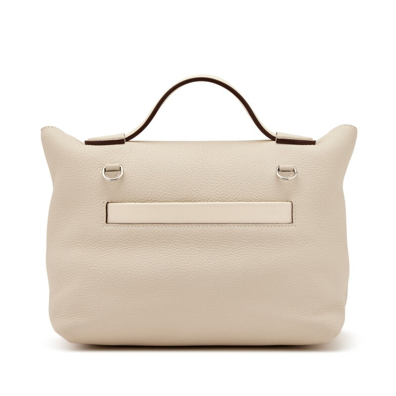 Hermès Nata Togo 24/24 tote bag showing the back side in beige with structured design and subtle branding.