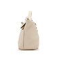 Hermès Nata Togo 24/24 tote bag in beige leather, shown from a side angle with gold hardware details.