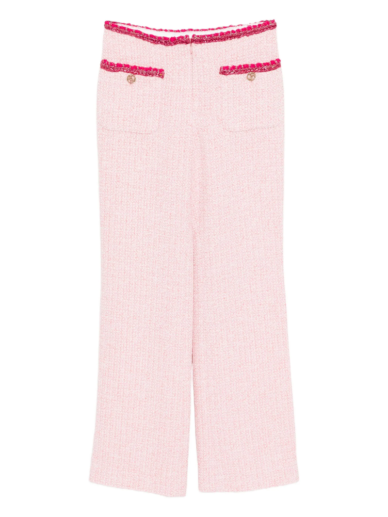 Pink Chanel tweed trousers with tailored fit and classic design, featuring textured fabric and subtle detailing.