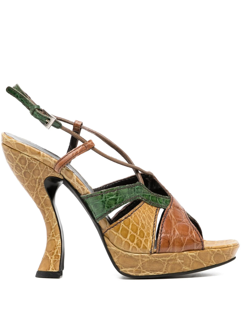 Multicolored high-heeled shoe with green, brown, and beige pattern on a white background