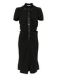 Black dress with short sleeves and a collar on a white background