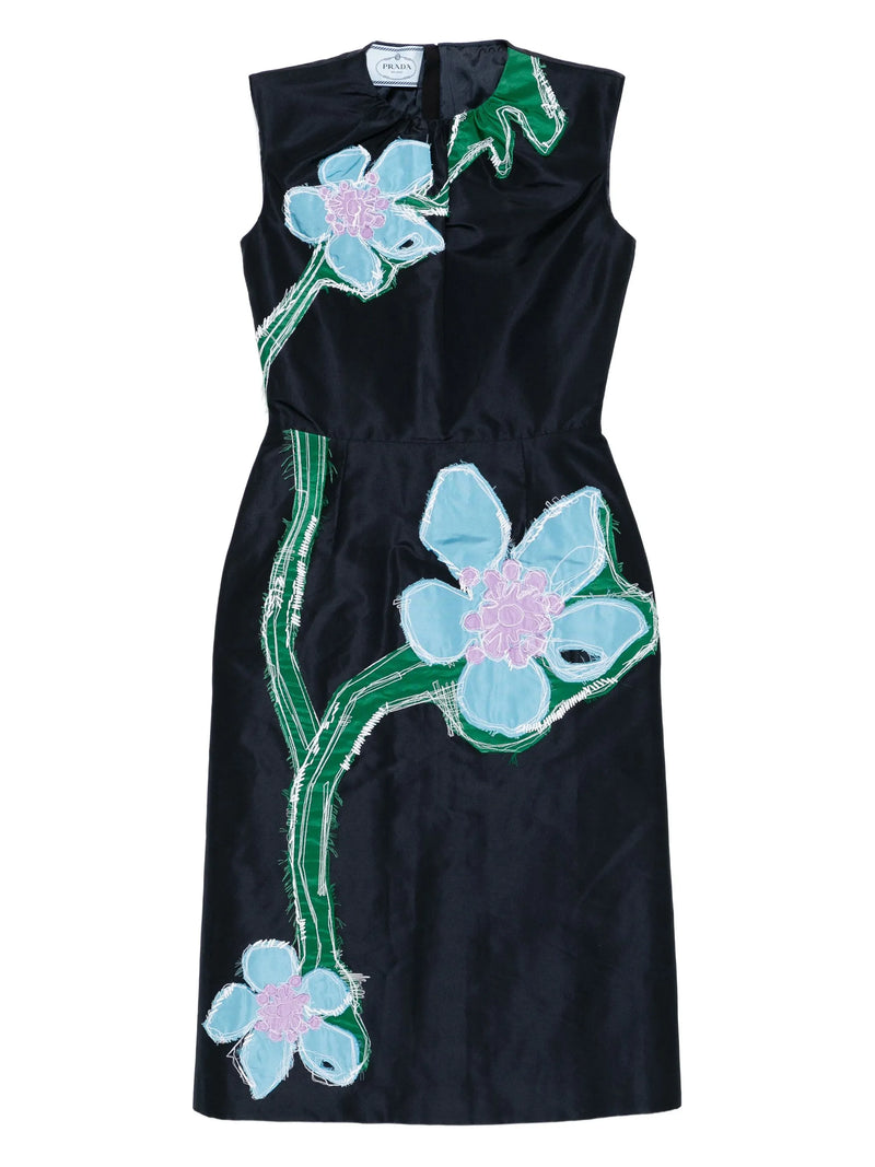 Black dress with floral designs on a white background