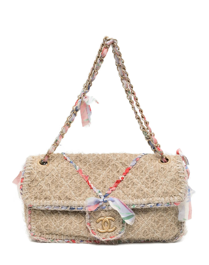 Chanel 2010 Straw Country Flap Bag shoulder bag with woven straw design and leather accents on a plain background