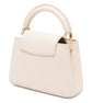 White handbag with gold accents on a white background