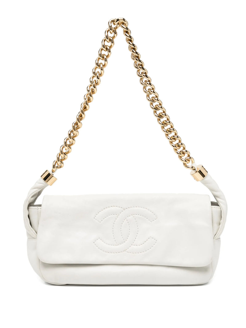 White handbag with gold chain strap on a white background