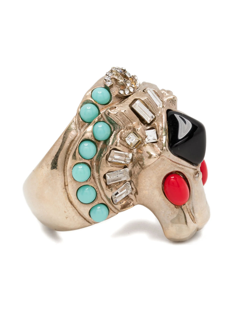 Chanel CC Lion Head Cocktail Ring with turquoise, black, and red stones on a white background