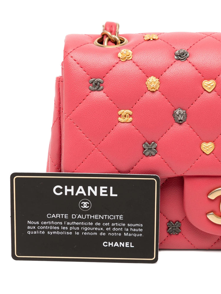 Chanel Classic Studded Flap Bag in Pink with decorative charms and authenticity card.