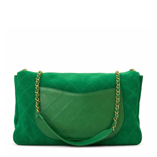 A green quilted suede shoulder bag with a silver-tone chain strap, shown from the back on a white background.