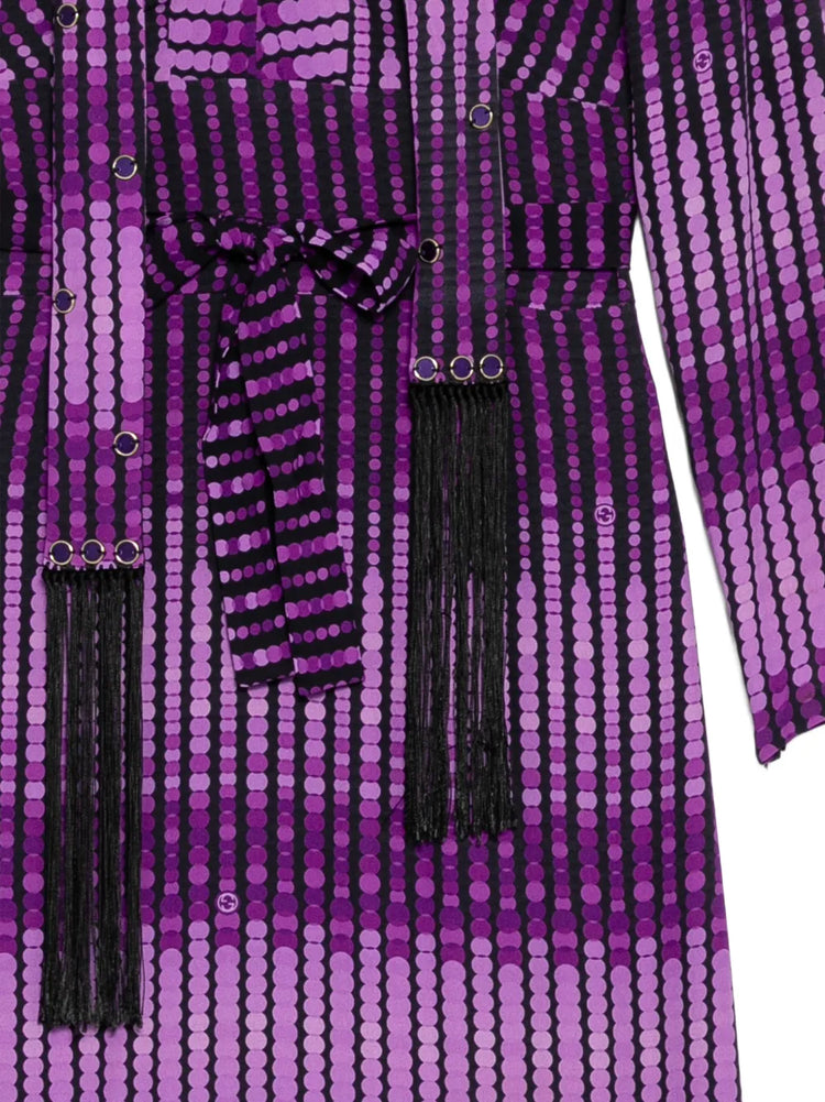 Close-up of a Gucci abstract print dress showcasing vibrant colors and intricate patterns on smooth fabric.