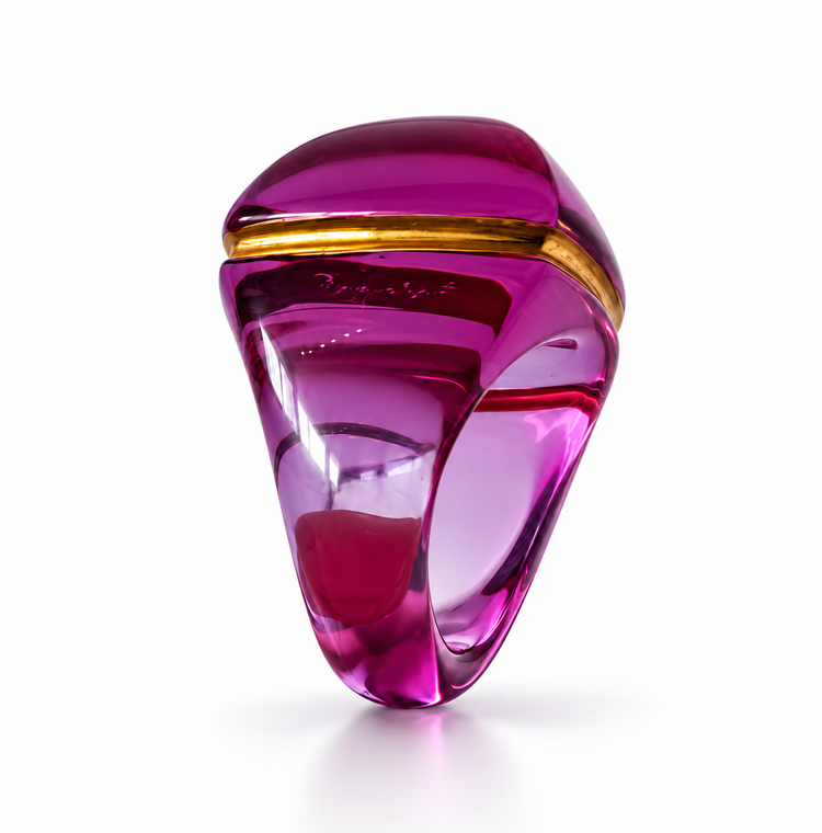 Baccarat Médicis Pop Ring in translucent magenta-purple crystal with sculptural rounded form and gold-tone accent detailing.