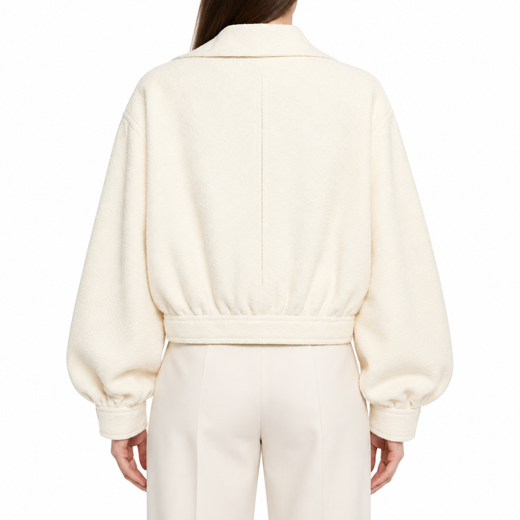 Beige Chanel cream tweed front zip blazer jacket with tailored fit and classic style, displayed on a hanger.
