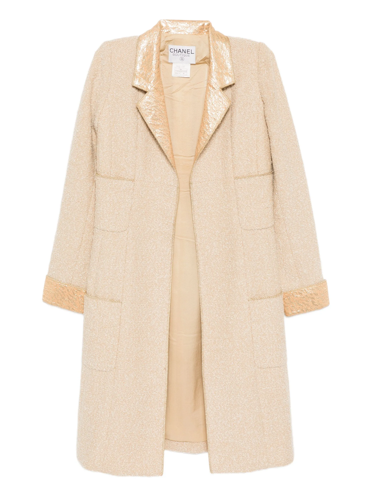 Beige wool bouclé Chanel coat with golden lamé accents, stylish and luxurious, shown on a hanger.