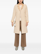 Beige wool bouclé coat with golden lamé accents, stylish Chanel coat displayed on a hanger.