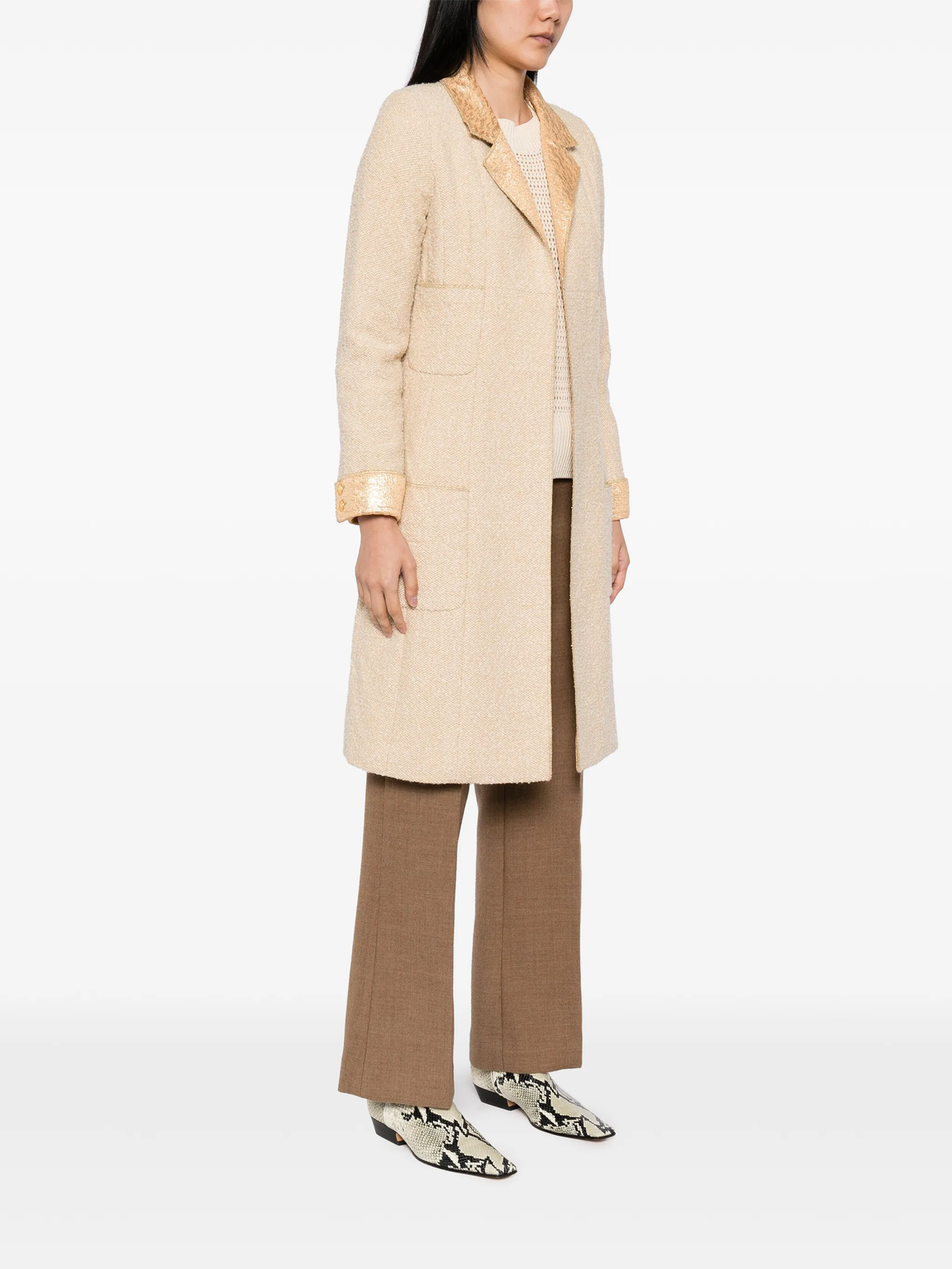 Beige wool bouclé Chanel coat with golden lamé accents, stylish and textured, designed for elegant winter wear.