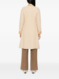 Beige wool bouclé Chanel coat with golden lamé accents, featuring a classic tailored design and luxurious texture.