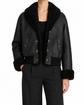Black leather shearling jacket by Chanel, stylish blazer with cozy shearling lining and sleek black leather exterior.