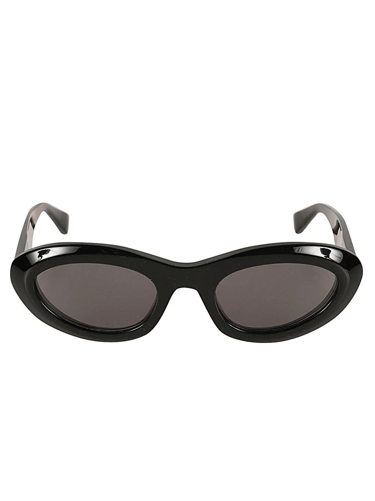 Bottega Veneta Almond Sunglasses in glossy black with narrow oval frames, dark tinted lenses and sculpted temples.
