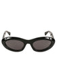 Bottega Veneta Almond Sunglasses in glossy black with narrow oval frames, dark tinted lenses and sculpted temples.