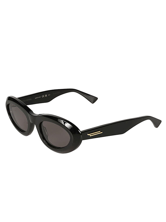 Bottega Veneta Almond Sunglasses in glossy black with narrow oval frames, dark tinted lenses and sculpted temples.