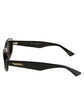 Black almond-shaped sunglasses by Bottega Veneta with sleek frames and tinted lenses.