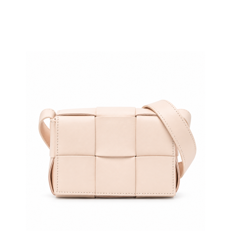Bottega Veneta Candy Cassette Crossbody Bag in blush pink leather with oversized intrecciato weaving, structured rectangular silhouette and adjustable shoulder strap.