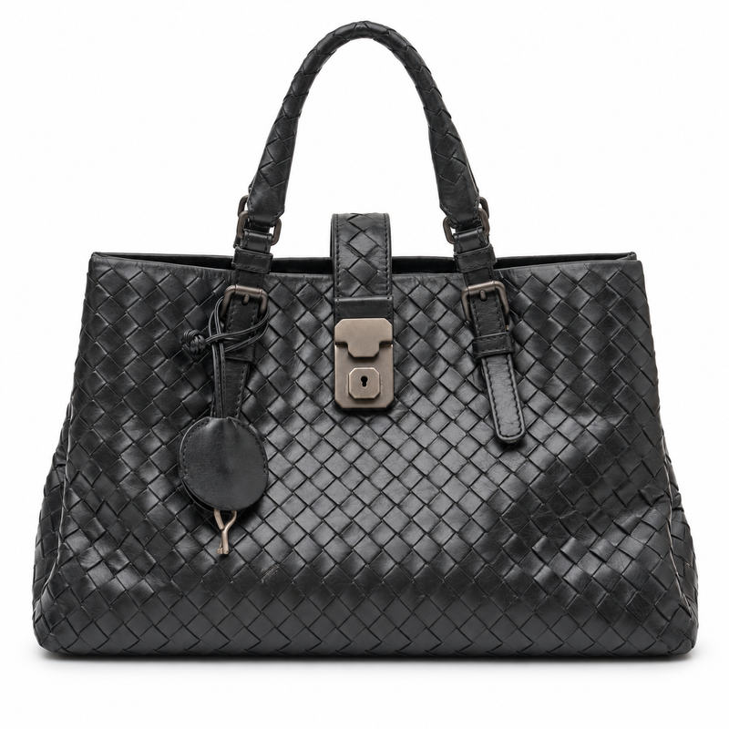 Bottega Veneta Intrecciato Roma Tote Bag in black woven leather with dual top handles, central metal lock fastening and hanging key clochette.
