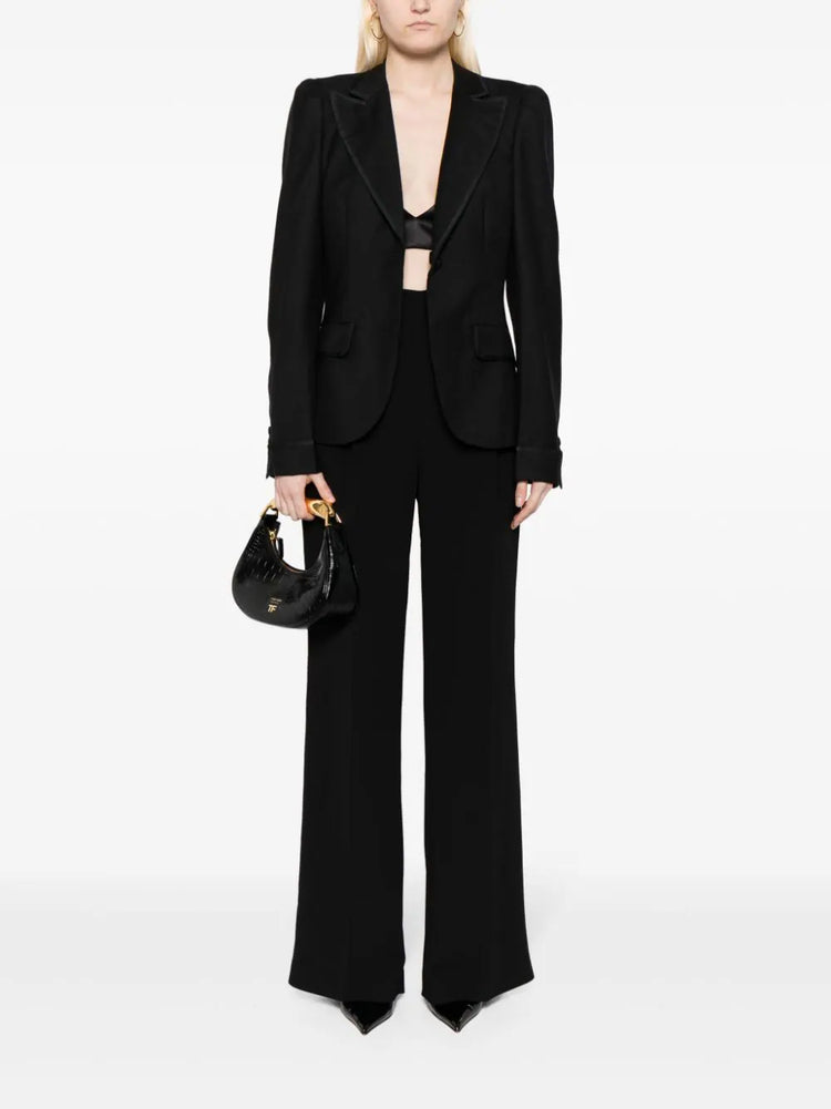 Bottega Veneta black single-breasted blazer with satin-trimmed notched lapels, single-button fastening, long sleeves and front flap pockets.