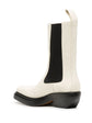 Bottega Veneta two-tone Western ankle boots in ivory leather with black elastic side panels, sculptural black sole, angled heel and rear pull tab.